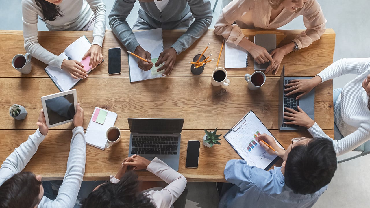 Promoting skill diversity in the workplace through inter-departmental collaboration at a table.