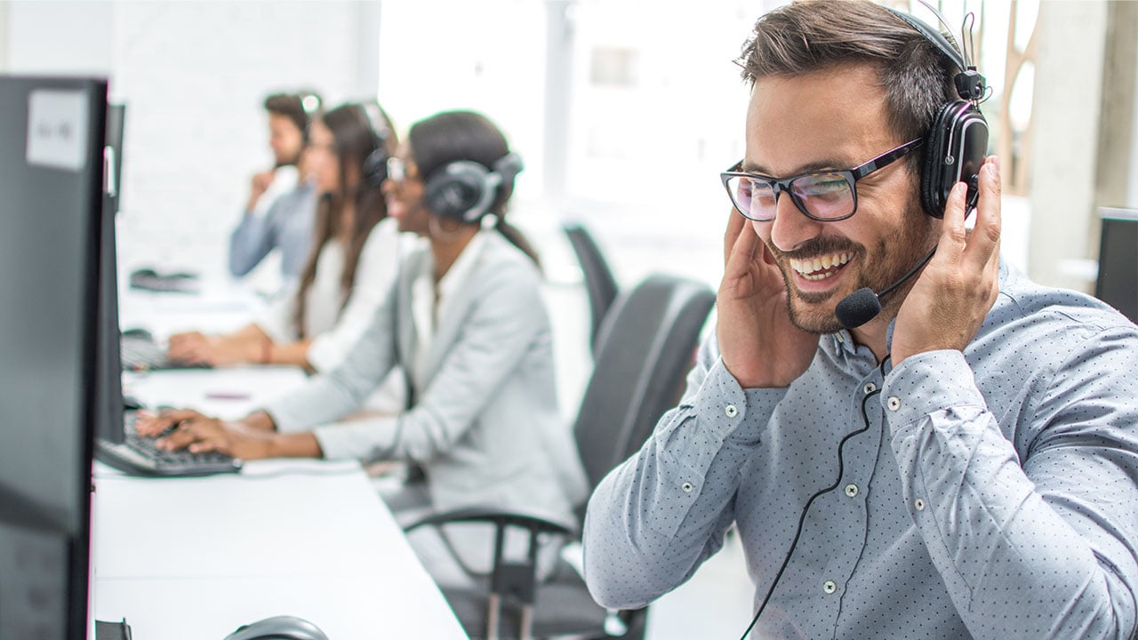 Man with headset working in customer service business process outsourcing 