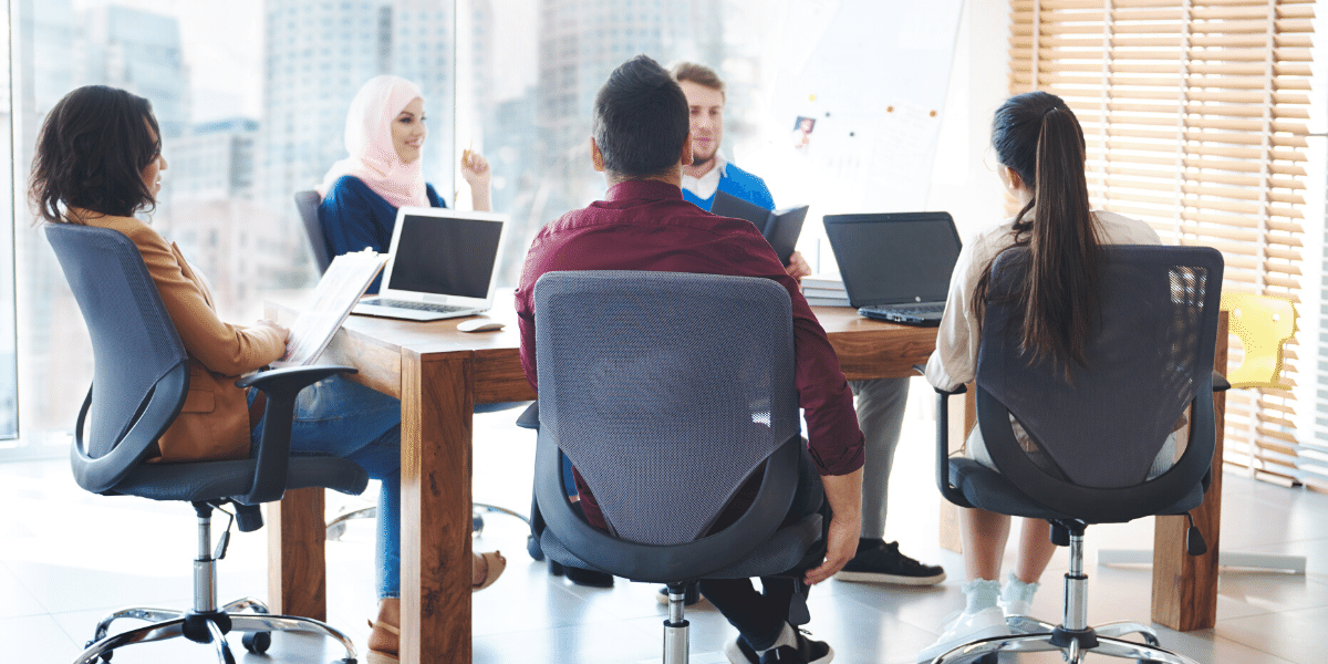 Group of people working around a table in a meeting room