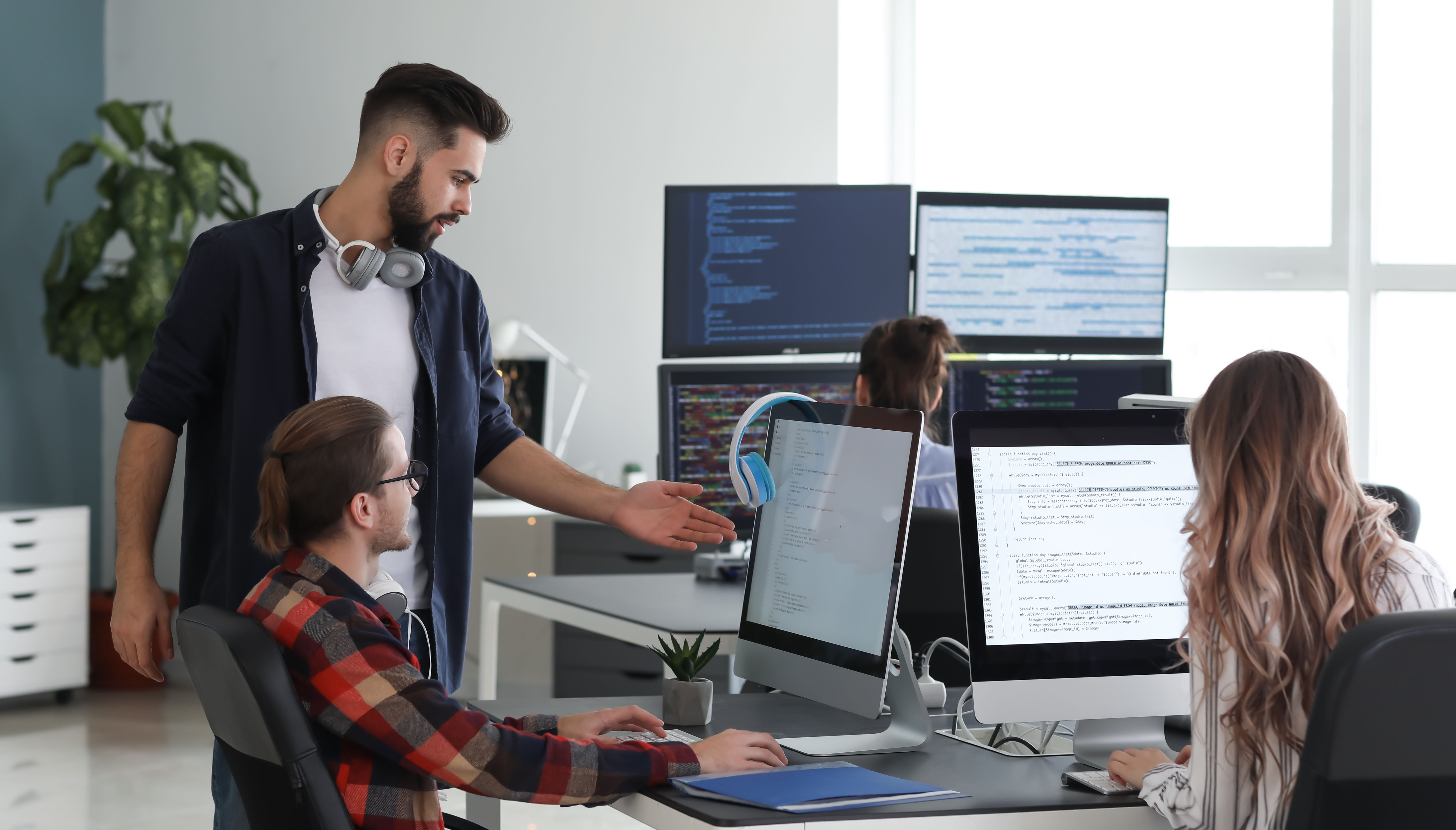 Man teaching woman IT skills in the office